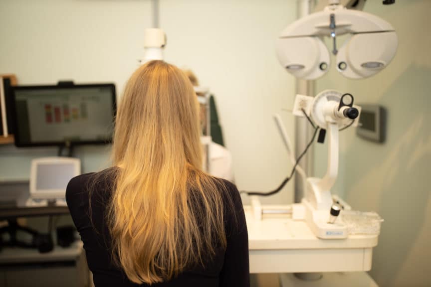 girl with long blonde hair in Specsavers test room